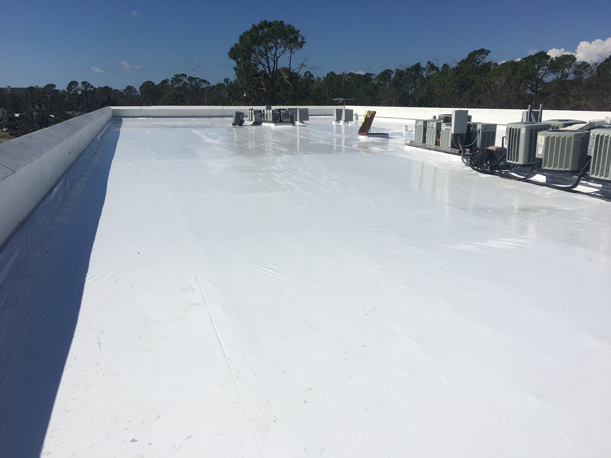 Shrink wrap covering a flat commercial roof around rooftop equipment